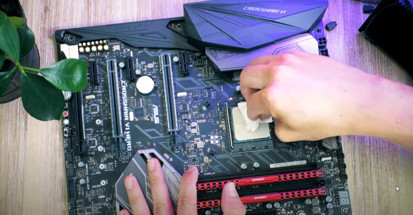 wiping the surface of the CPU with a cotton swab